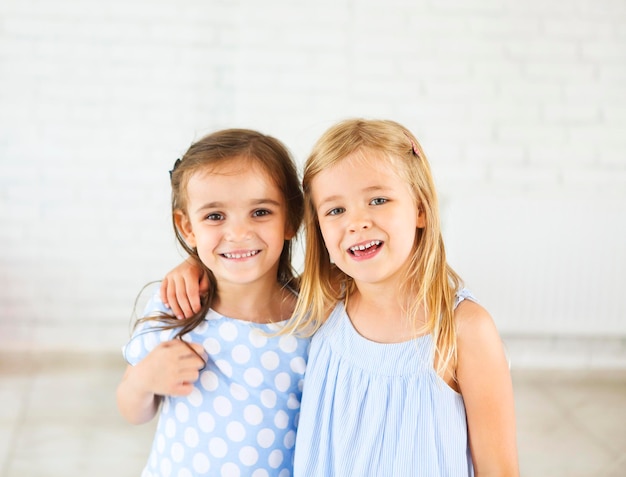 Foto retrato de chicas sonrientes contra la pared