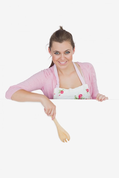 Foto retrato de la criada que señala con la cuchara de madera