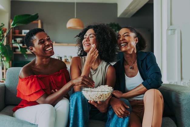 Retrato de amigos sorridente sentados no sofá em casa