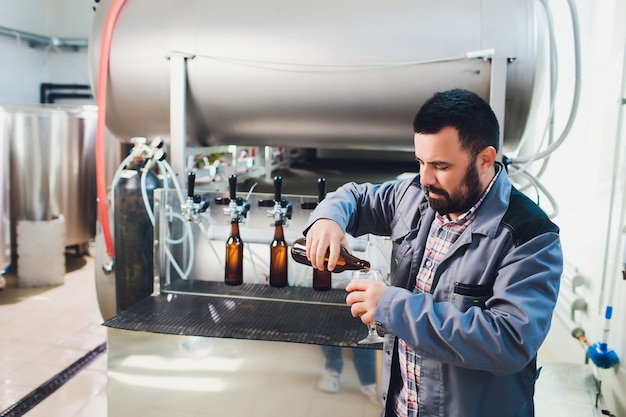 Retrato de cervejeiro fazendo cerveja no seu local de trabalho na cervejaria