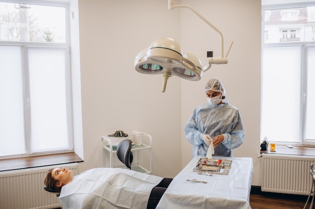 Retrato de cirurgiã usando esfoliação e óculos de proteção no centro cirúrgico do hospital