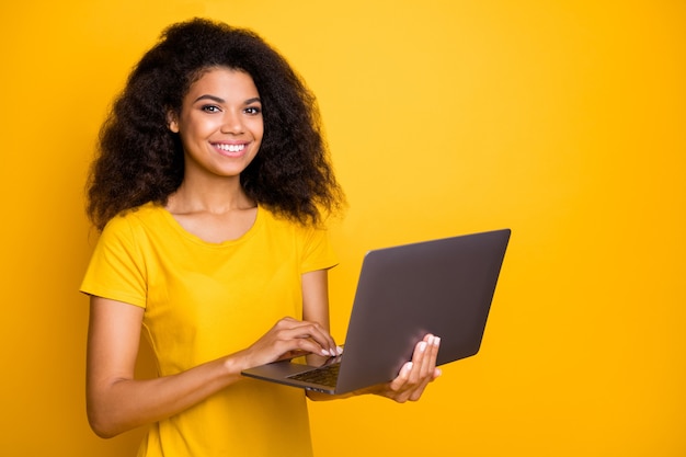 Retrato de close-up alegre garota segurando nas mãos usando um laptop