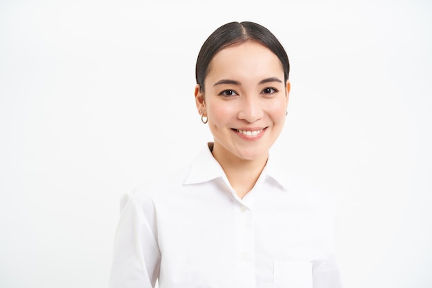 Retrato de empresária coreana em camisa sorri para o conceito de câmera de pessoas corporativas e negócios