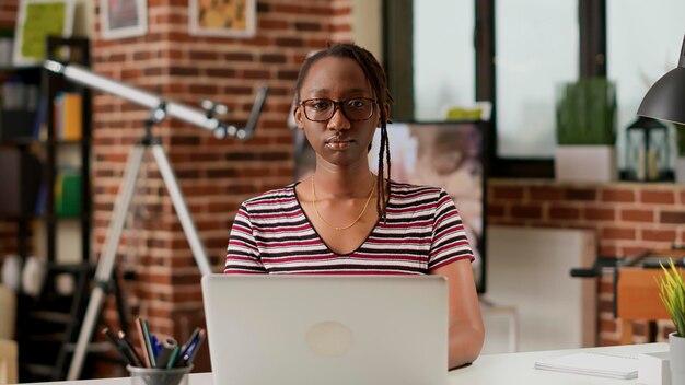 Retrato de empresária usando laptop para fazer trabalho remoto em home office, trabalhando na inicialização com computador e rede online. Empregado trabalhando remotamente, trabalho freelance distante.