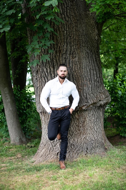 Retrato de empresário confiante em pé ao ar livre no parque