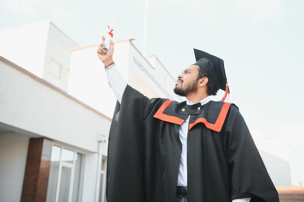 Retrato de estudante indiano bem sucedido em vestido de formatura