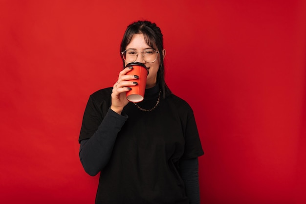 Retrato de estúdio de uma bela jovem sorridente gostando dela para ir tomar café