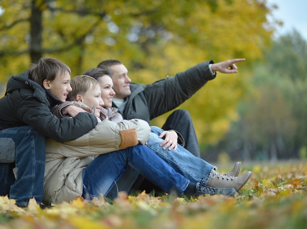 Retrato de família feliz relaxando no parque outono