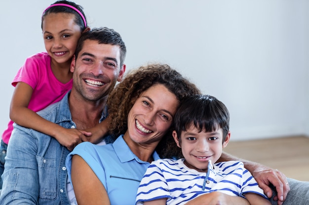 Retrato de família feliz sentados juntos no sofá