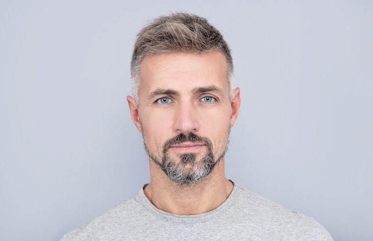 Foto retrato de homem maduro. cara adulto tem cabelos grisalhos. homem bonito com barba grisalha. moda de cabelo masculino. barbearia. cara de cara com a barba por fazer. cabelos e cuidados com a pele. skincare masculino. beleza dos homens.