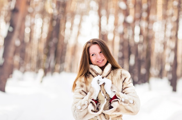 Retrato de inverno de mulher jovem e bonita com casaco de pele. conceito de moda neve inverno beleza.