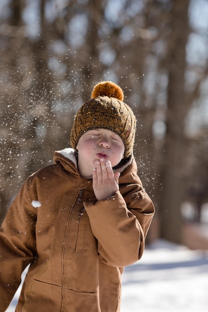 Retrato de inverno de um menino ativo ao ar livre com crianças no inverno
