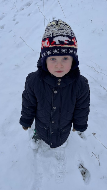 Retrato de inverno de um menino em roupas quentes