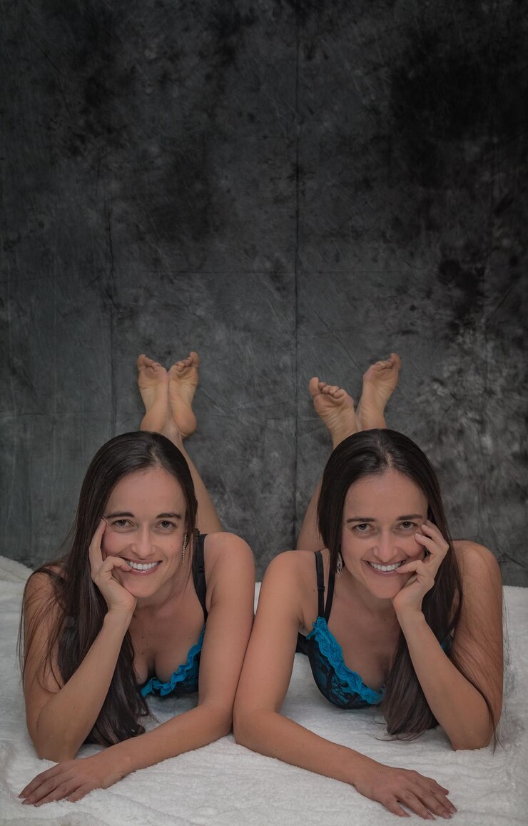 Foto retrato de irmã sorridente deitada na cama contra a parede