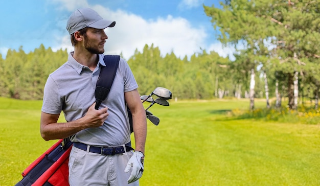 Retrato de jogador de golfe masculino carregando saco de golfe enquanto caminhava pela grama verde do clube de golfe