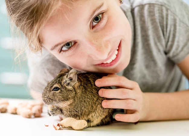 Retrato de jovem com esquilo degu e closeup de nozes