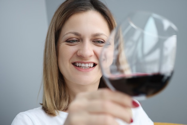 Retrato de jovem com um copo de vinho tinto na mão