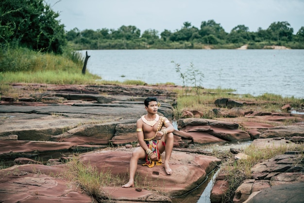 Retrato de jovem em traje tradicional posando na natureza na Tailândia