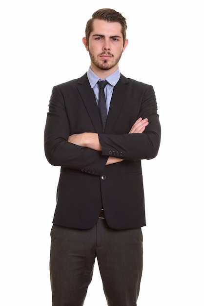 Retrato de jovem empresário barbudo bonito de terno