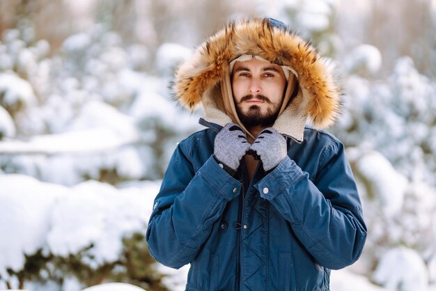 Retrato de jovem na floresta de inverno nevado Temporada de viagens de natal e conceito de pessoas