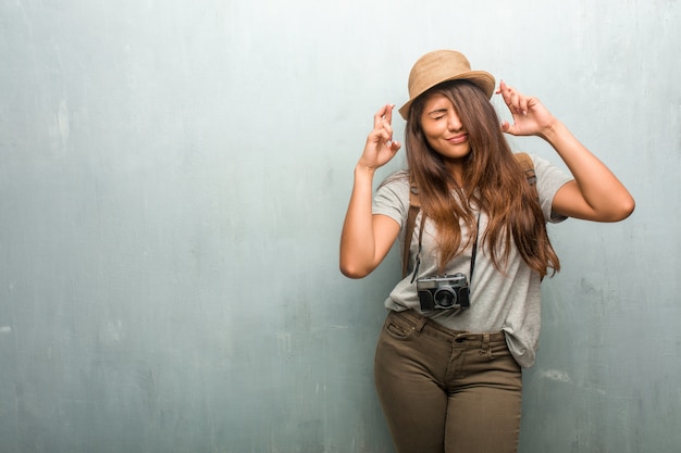 Retrato, de, jovem, viajante, latim, mulher, contra, um, parede, cruzando, seu, dedos