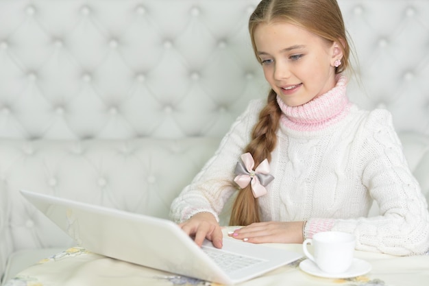 Retrato de linda linda garota usando laptop