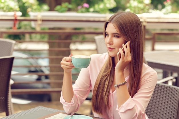 Retrato, de, menina bonita, usando, dela, telefone móvel, em, café