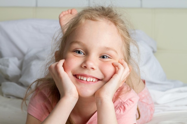 Retrato de menina bonitinha sonhando na cama