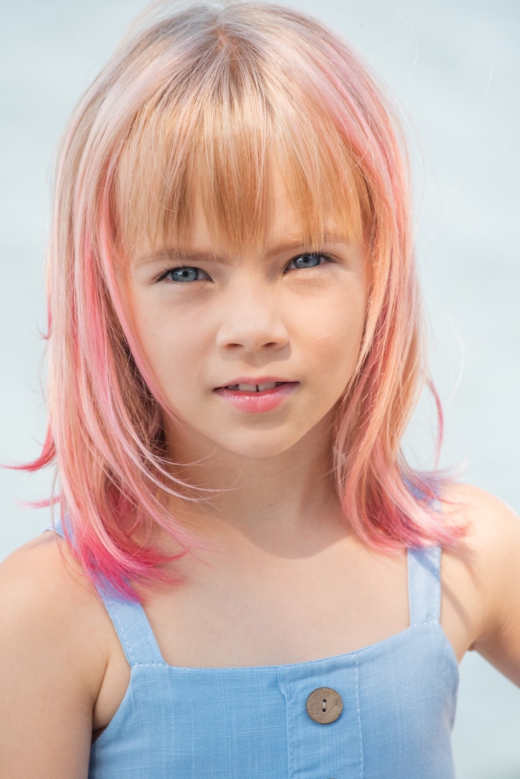 Foto retrato de menina criança fofa. retrato ao ar livre da menina bonitinha em dia de verão. menina com cabelo rosa