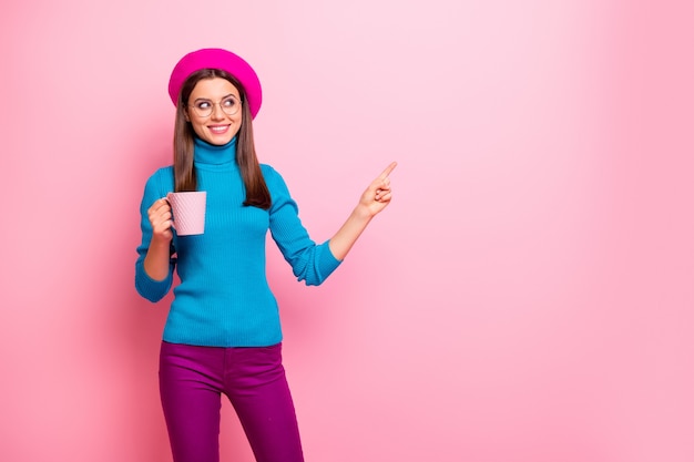 Retrato de menina francesa viagem ponto de viagem dedo indicador cópia espaço positivo show café cafeteria promoção de vendas segurar copo latte anúncios usar calças azuis.