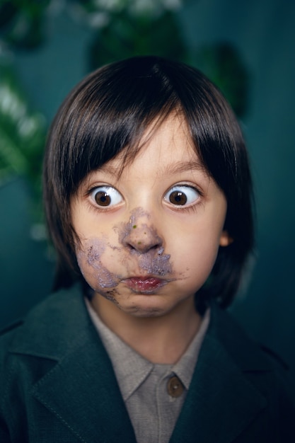 Retrato de menino com cara de bolo manchado