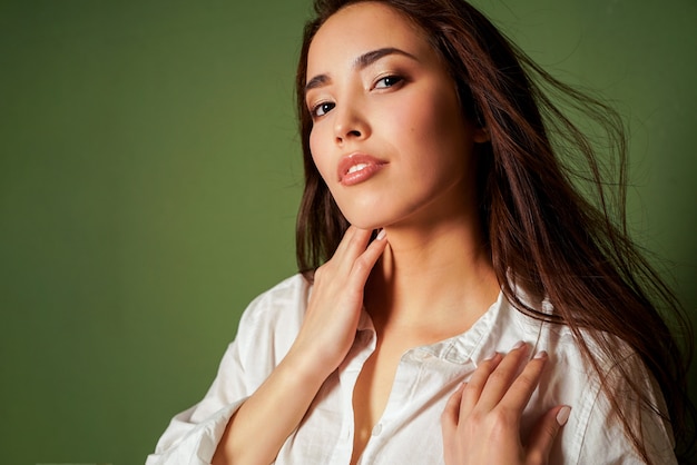 Foto retrato de moda beleza sexy sensual jovem asiática com cabelo longo escuro na camisa branca em verde