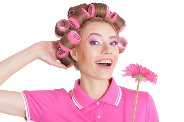 Retrato de mulher bonita com rolos de cabelo com flor em estúdio