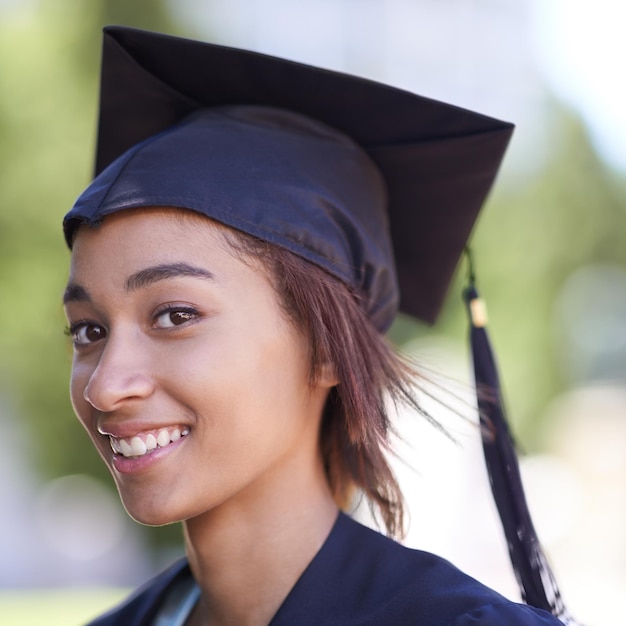 Foto retrato de mulher com pós-graduação e realização com chapéu e vestido de educação para cerimônia ao ar livre sorrisão universitária e evento de formatura para sucesso acadêmico aprendizagem superior e certificação com orgulho