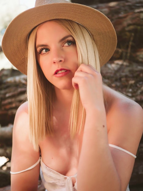 Retrato de mulher estilosa em vestido de verão com chapéu na natureza