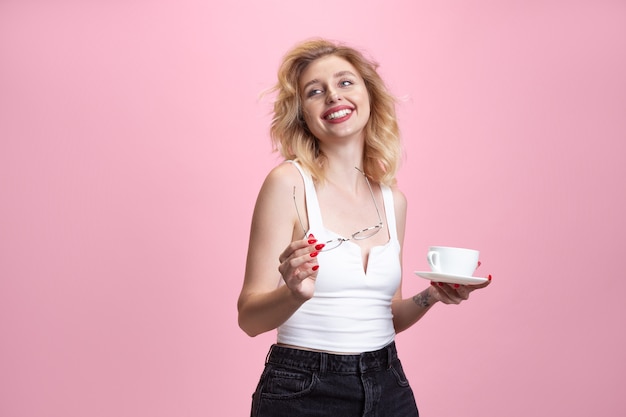 Retrato de mulher jovem caucasiana isolado no fundo rosa do estúdio. Linda modelo feminino.