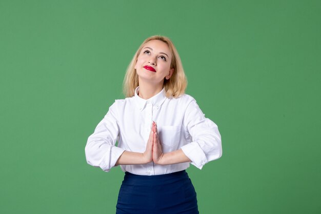 retrato de mulher jovem em roupas conservadoras, sonhando com parede verde, aluna de estudo