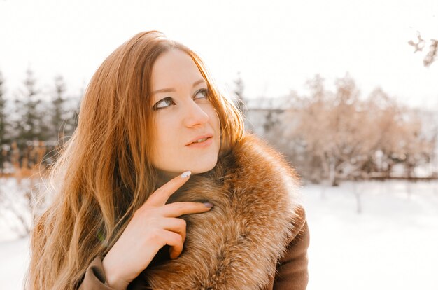 Retrato de mulher ruiva atraente em winter park