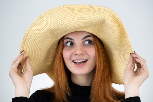 Retrato de mulher ruiva engraçada no chapéu de palha saco.