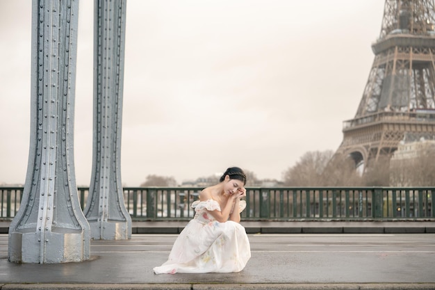 Retrato de mulher sob a ponte Bir Hakeim com a Torre Eiffel Paris França