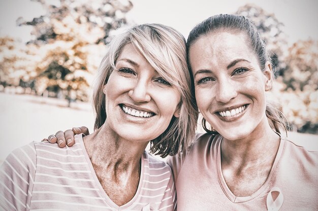 Retrato de mulheres voluntárias confiantes participando da conscientização sobre o câncer de mama no parque