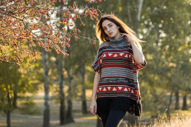 Retrato de outono de uma garota com um suéter étnico