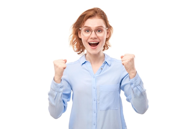 Retrato de ruiva positiva na camisa de negócios se alegra emocionalmente e se sente feliz isolado no banner de publicidade de fundo branco