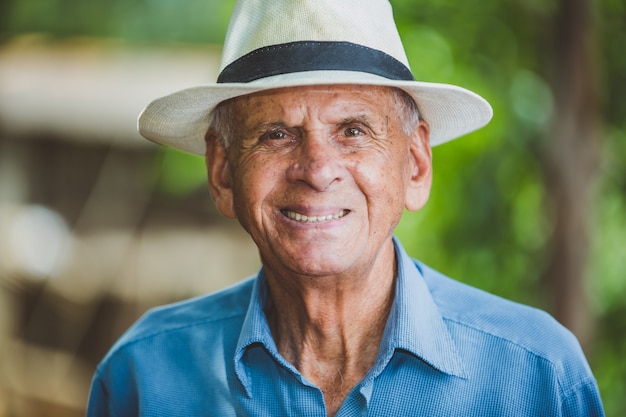 Retrato de sorrir mais velho agricultor masculino com chapéu