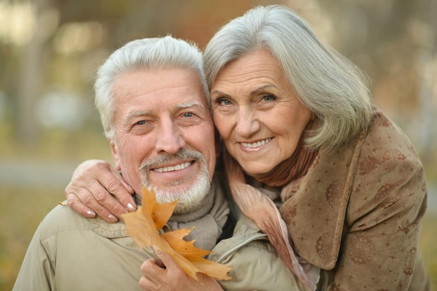 Retrato de um casal feliz de idosos no parque outono