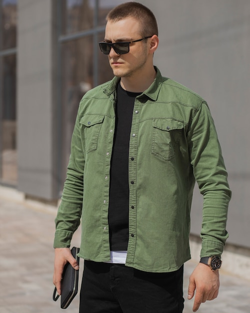 Retrato de um empresário adulto de sucesso com uma camisa verde e um relógio caro