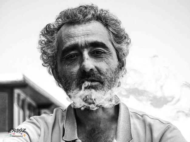 Foto retrato de um homem adulto fumando