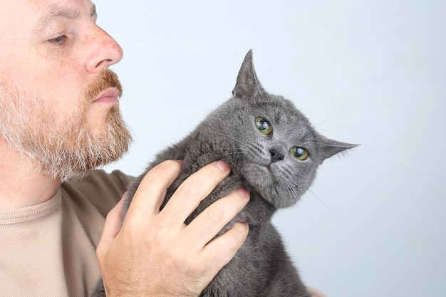 Retrato de um homem barbudo com um gato cinza