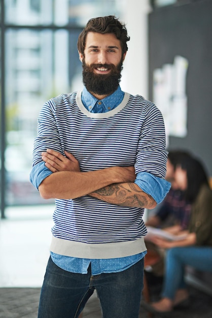 Retrato de um homem criativo e de negócios com os braços cruzados no escritório de uma startup para uma carreira na Itália Sorriso confiante profissional e empreendedor designer e empregado feliz trabalhando na empresa para um emprego
