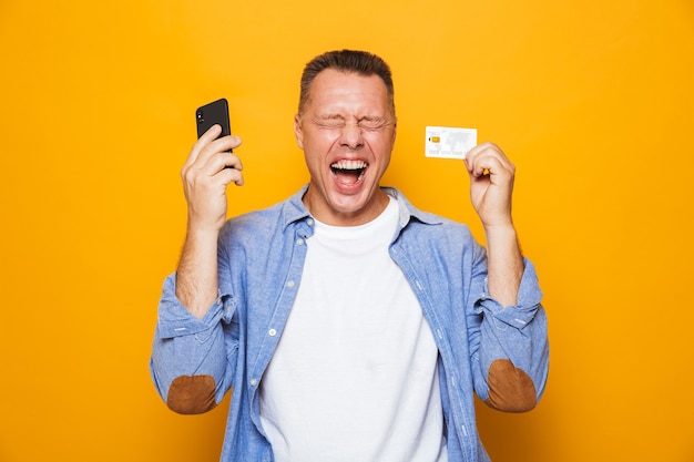 Retrato de um homem de meia-idade feliz usando telefone celular